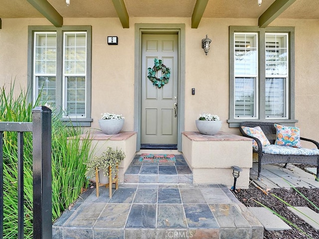 doorway to property with stucco siding