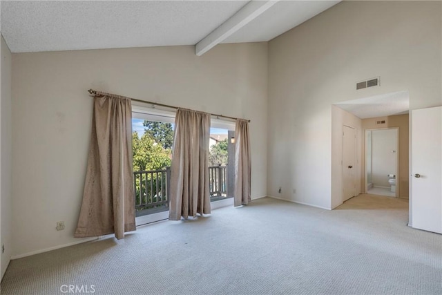 unfurnished room with a textured ceiling, high vaulted ceiling, light colored carpet, visible vents, and beam ceiling