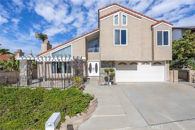 view of front of property with stucco siding, concrete driveway, an attached garage, fence, and a tiled roof