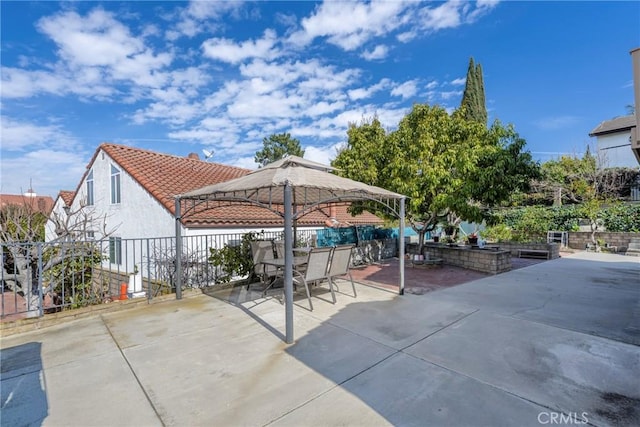 view of patio with fence and a gazebo