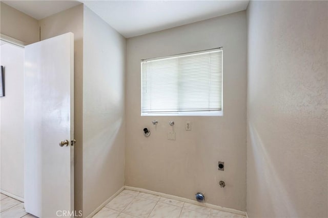 clothes washing area with baseboards, laundry area, electric dryer hookup, and hookup for a gas dryer