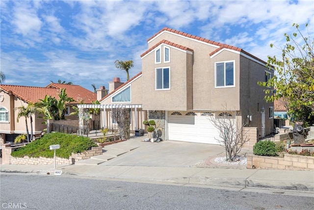 view of front of home featuring a garage, concrete driveway, a tile roof, and stucco siding