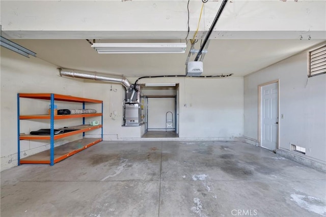 garage with a garage door opener and heating unit