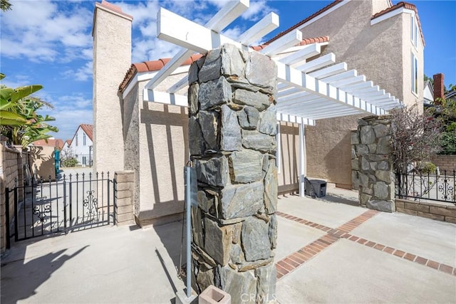 view of patio / terrace featuring fence and a pergola