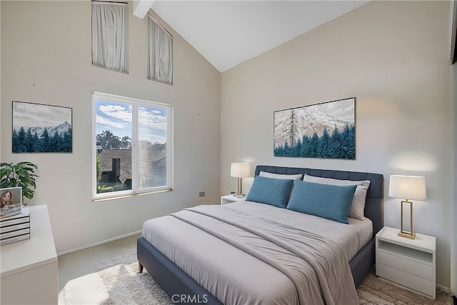 bedroom with high vaulted ceiling, light carpet, and baseboards