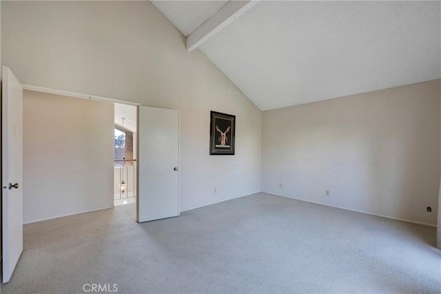 spare room featuring high vaulted ceiling, beam ceiling, and light carpet