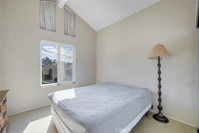 carpeted bedroom with vaulted ceiling and baseboards