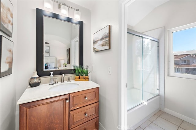 bathroom featuring shower / bath combination with glass door, vanity, baseboards, and tile patterned floors