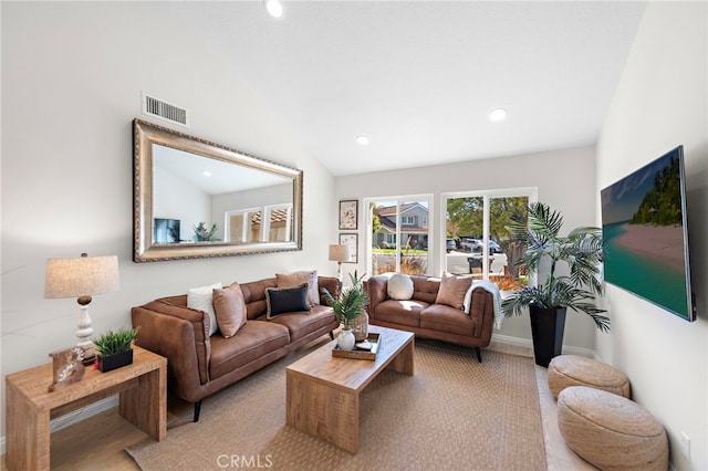 living area with recessed lighting, visible vents, vaulted ceiling, and baseboards