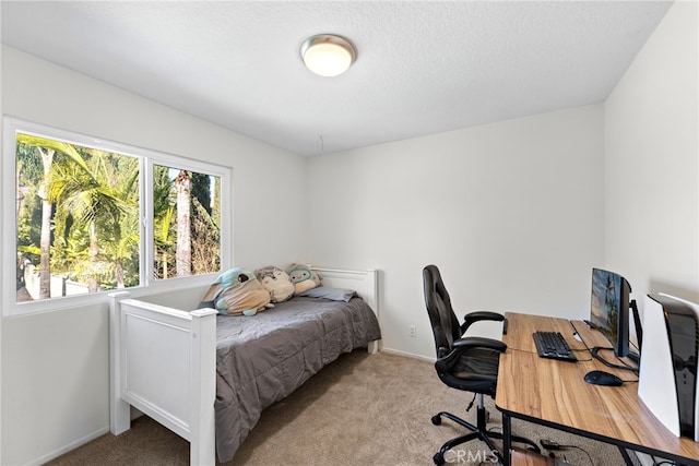 carpeted bedroom with a textured ceiling and baseboards