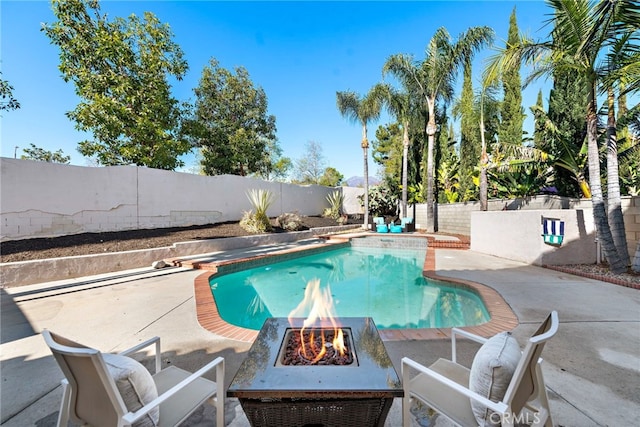 view of pool with a patio area, a fenced backyard, an outdoor fire pit, and a fenced in pool