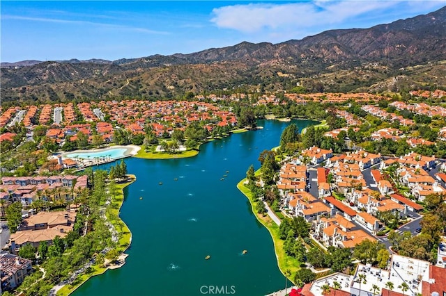 drone / aerial view featuring a residential view and a water and mountain view