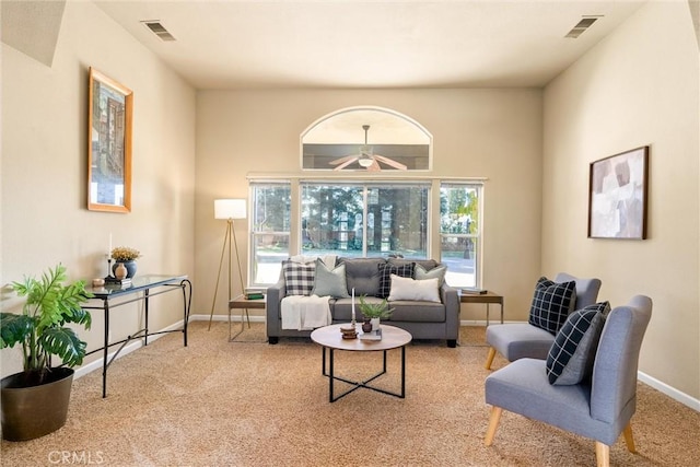 living area with light colored carpet, visible vents, and baseboards