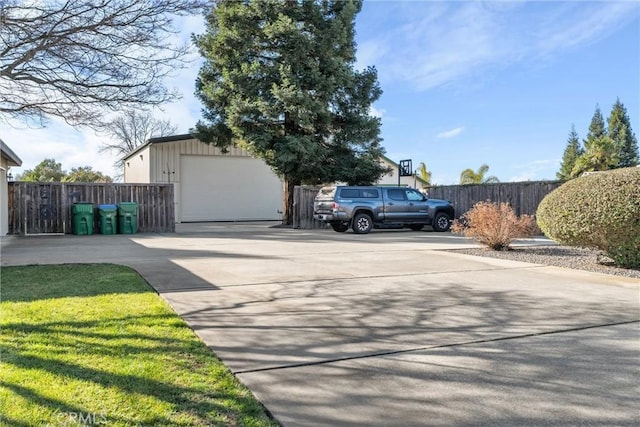 exterior space with a garage, fence, and driveway