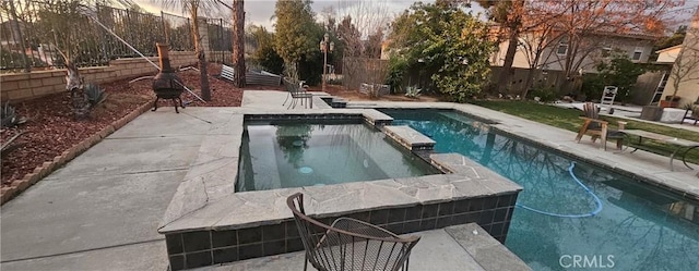 view of swimming pool with a patio area, a fenced backyard, and a pool with connected hot tub