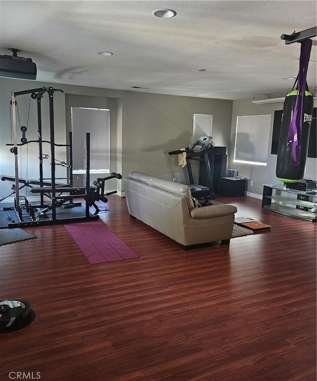 living area with a textured ceiling and wood finished floors