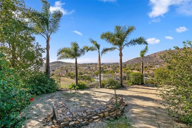 exterior space featuring fence and a mountain view