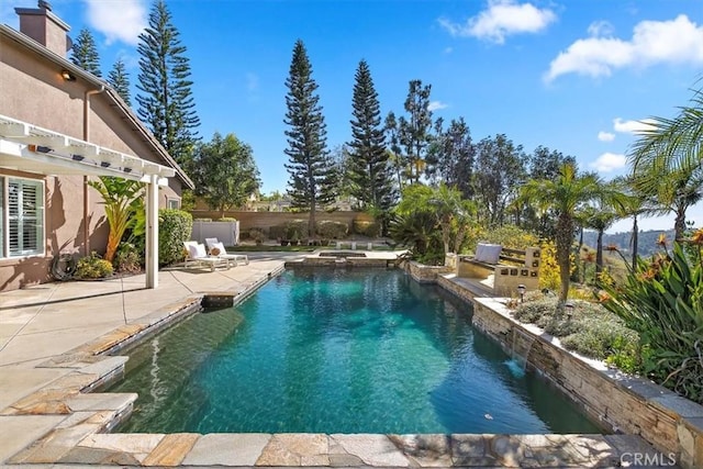 view of swimming pool with a patio area, fence, and a pool with connected hot tub