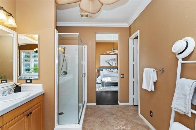 full bathroom with a stall shower, ceiling fan, ornamental molding, tile patterned floors, and vanity