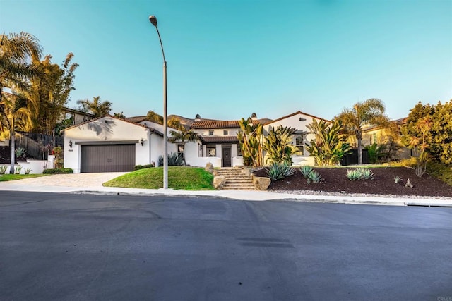 mediterranean / spanish-style home with driveway and an attached garage