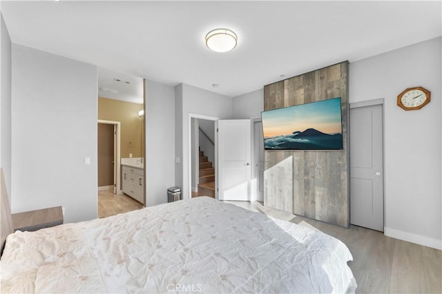 bedroom featuring light wood-type flooring and baseboards