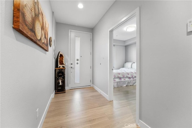 interior space featuring light wood-type flooring and baseboards