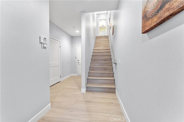 stairs with baseboards and wood finished floors