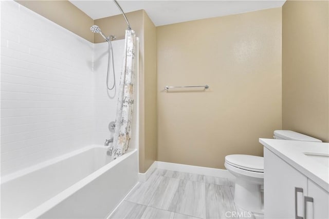 bathroom with shower / bath combo, toilet, vanity, and baseboards