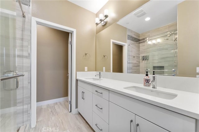 bathroom featuring a sink, visible vents, baseboards, a shower stall, and double vanity