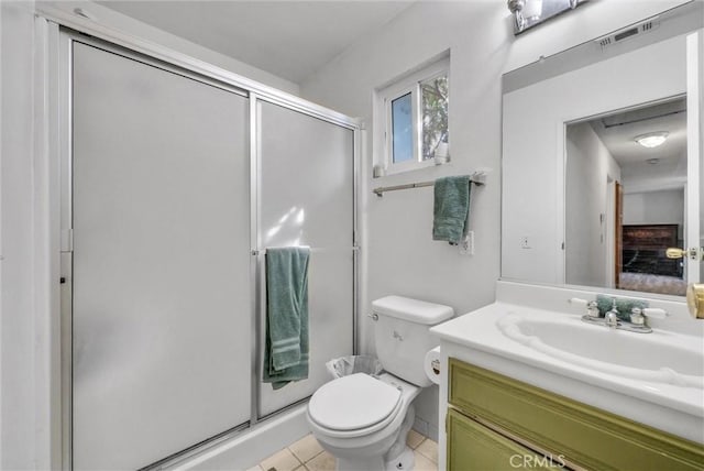 ensuite bathroom featuring visible vents, toilet, tile patterned floors, vanity, and a shower stall