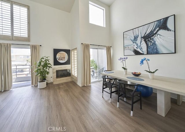 1617 S Beverly Glen Blvd Unit 303, Los Angeles, CA 90024 - home office with a high ceiling, wood finished floors, and a glass covered fireplace