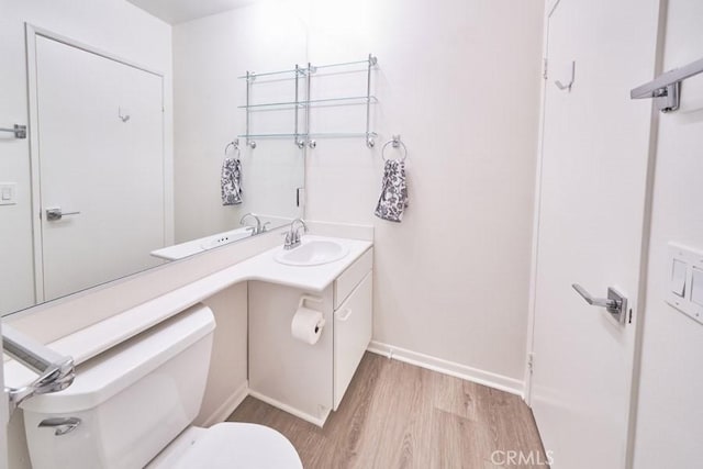 1617 S Beverly Glen Blvd Unit 303, Los Angeles, CA 90024 - bathroom with wood finished floors, toilet, vanity, and baseboards