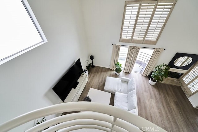 1617 S Beverly Glen Blvd Unit 303, Los Angeles, CA 90024 - living area featuring wood finished floors and a towering ceiling