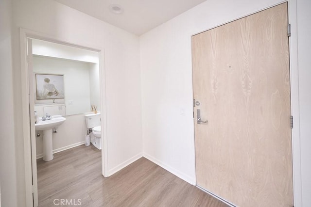 1617 S Beverly Glen Blvd Unit 303, Los Angeles, CA 90024 - corridor with light wood-type flooring, baseboards, and a sink