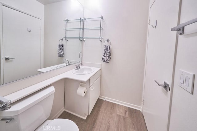 1617 S Beverly Glen Blvd Unit 303, Los Angeles, CA 90024 - bathroom with wood finished floors, toilet, vanity, and baseboards