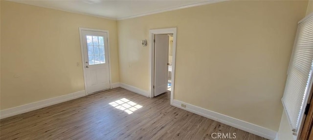 empty room with light wood-style flooring and baseboards