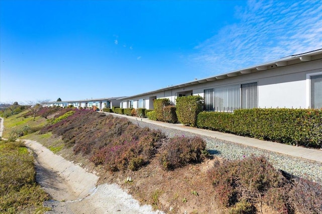 view of side of home featuring stucco siding