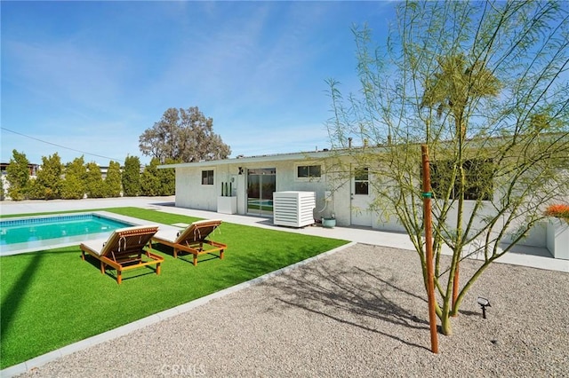 back of property featuring a patio area, central AC unit, an outdoor pool, and a lawn