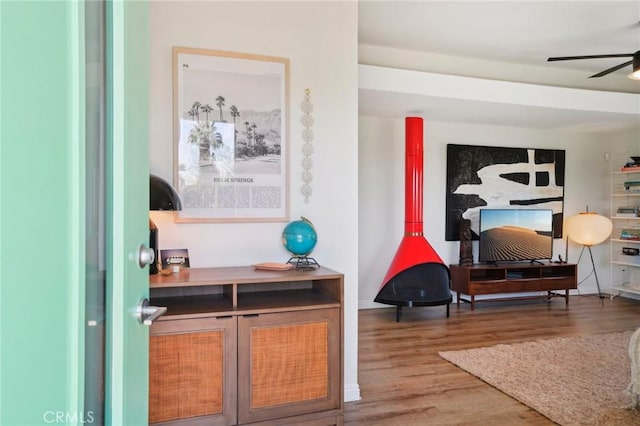 sitting room with a ceiling fan and wood finished floors