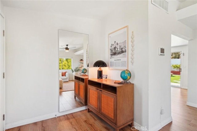 interior space featuring light wood-style floors, baseboards, and visible vents