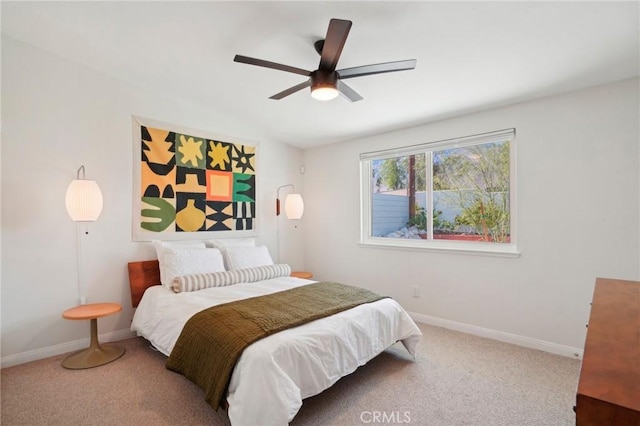 carpeted bedroom with baseboards, vaulted ceiling, and a ceiling fan