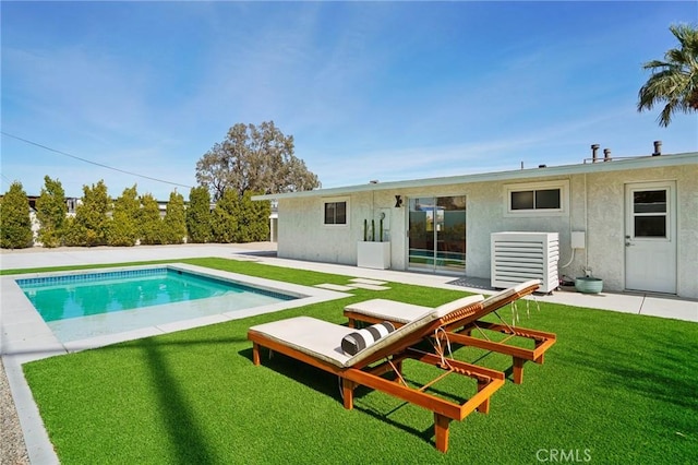 rear view of property featuring a patio, central AC unit, an outdoor pool, a yard, and stucco siding