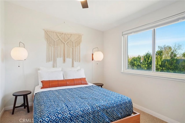 carpeted bedroom with baseboards and a ceiling fan