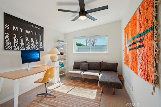 home office with a ceiling fan, carpet, vaulted ceiling, and baseboards