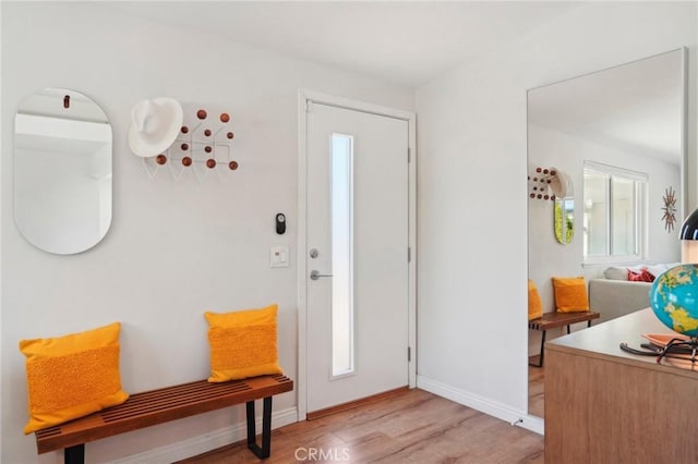 foyer entrance featuring light wood-style flooring and baseboards