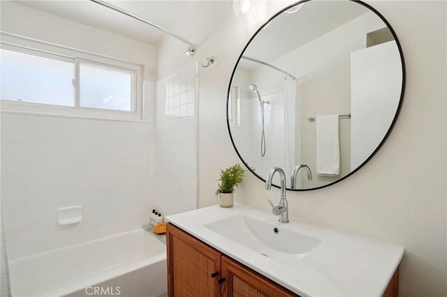 bathroom featuring shower / tub combo and vanity