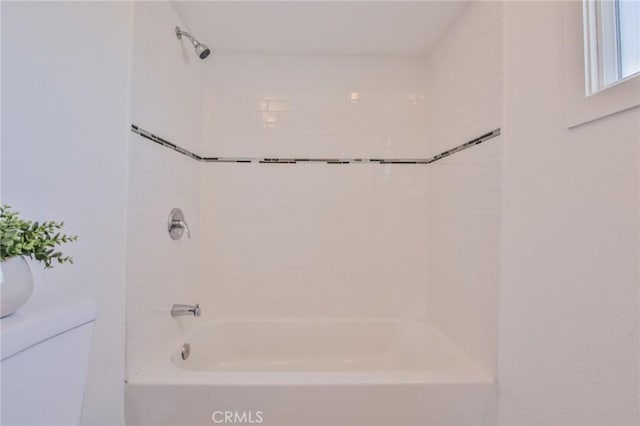 bathroom with toilet and shower / bathtub combination