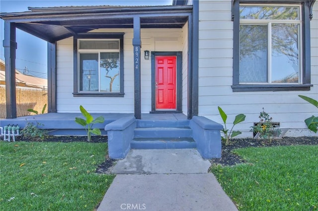 doorway to property featuring a yard and crawl space