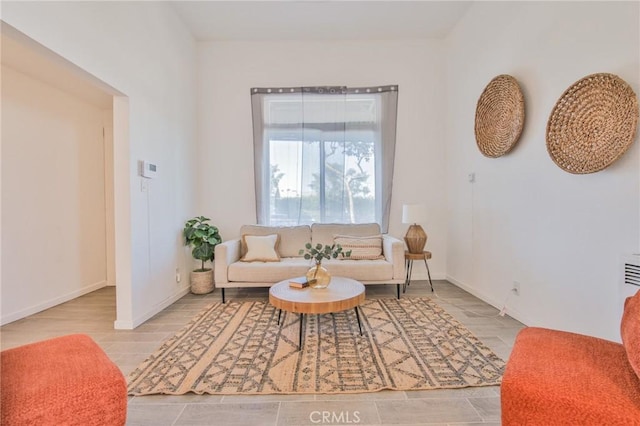 living room featuring wood finished floors and baseboards