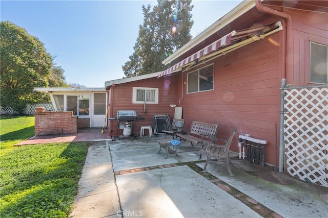 back of house featuring a patio and a lawn